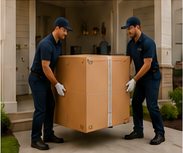 Delivery professionals carrying a boxed product toward a customer’s home