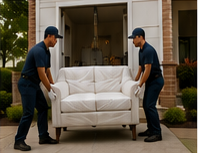 White-glove delivery team preparing a wrapped sofa outside a residence