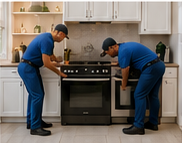 Experienced delivery assemblers installing an appliance in a customer’s kitchen