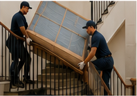 Delivery professionals safely moving a large item on a residential staircase